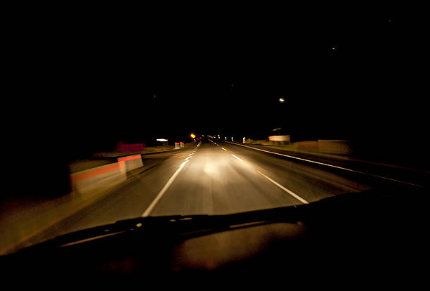 istock Car driving along road during night 515719363