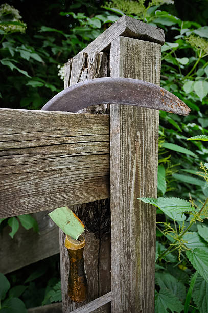 Sickle hanging on fence