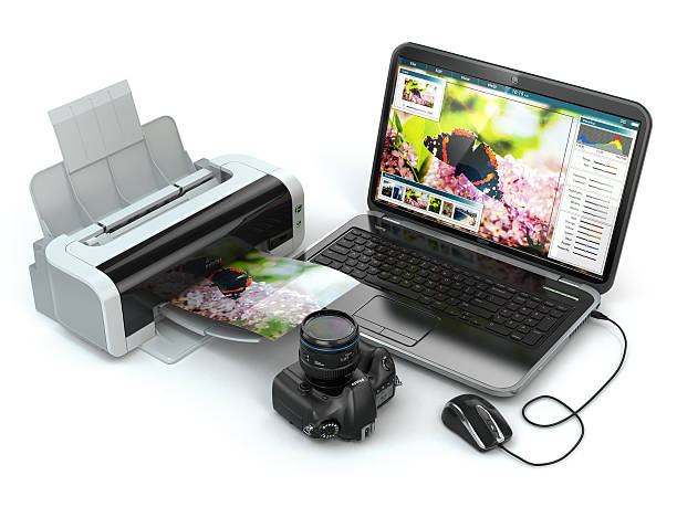 istock Laptop, photo camera and printer. Preparing images for print. 515724217