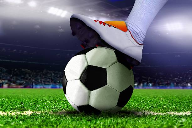 istock Feet on Soccer Ball in the Stadium 515724733