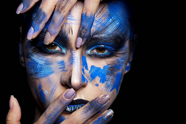 istock girl in blue paint on his face 515736198