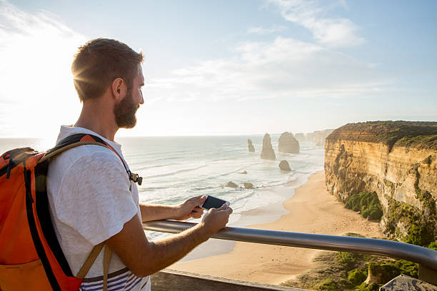 istock Tourist at the Twelve Apostles using mobile phone-Australia 515738440