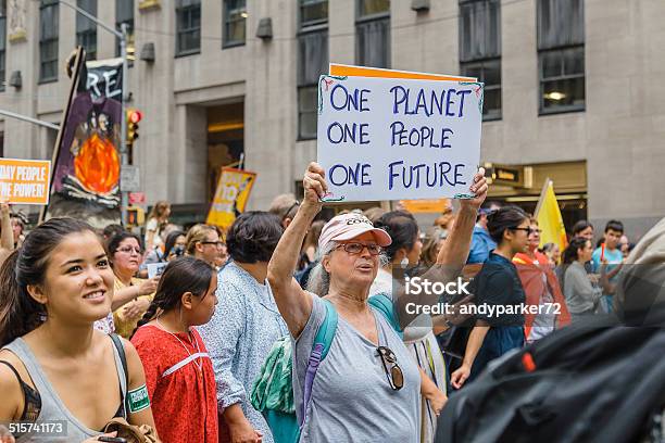 Woman Carries Placard During The 2014 Peoples Climate March Nyc Stock Photo - Download Image Now