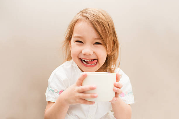 Little cute and sweet girl with tea stock photo