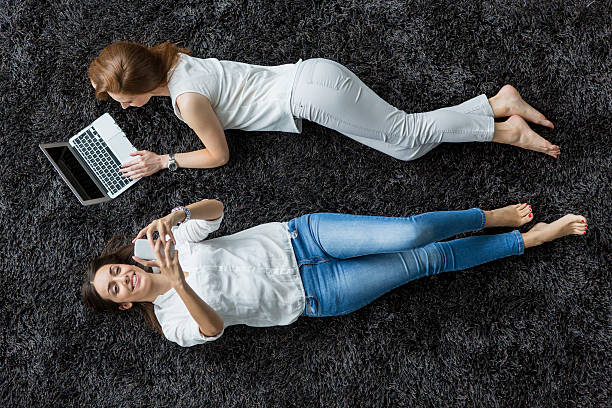 istock Young women relaxing on the carpet 515742483