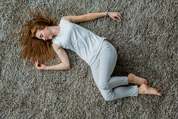 istock Young woman laying on the carpet 515742497