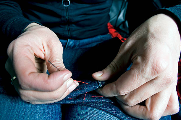 istock Woman sawing jeans pants 515742727