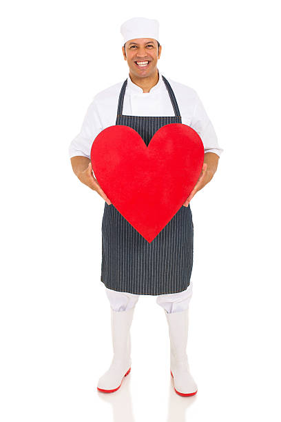 istock mid age butcher holding heart 515742806
