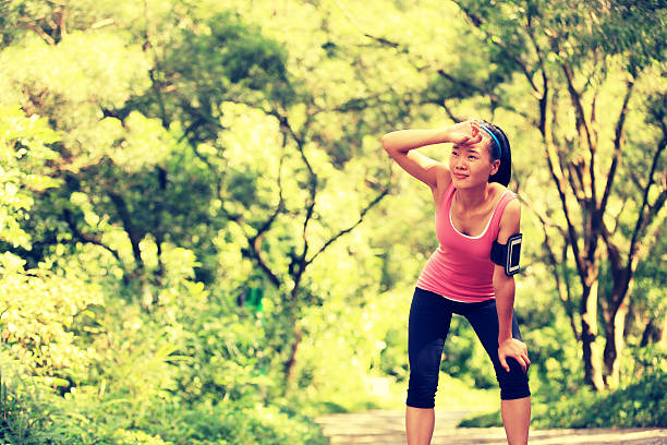 istock tired woman runner have a rest after running hard 515743037