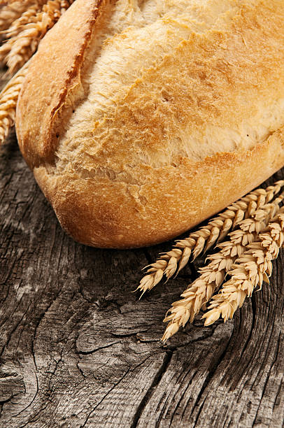 istock loaf of bread with ears of wheat 515743390