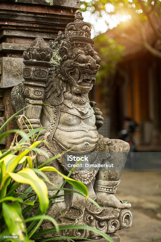 Traditional demon guard statue carved in stone on Bali Traditional demon guard statue carved in stone on Bali, Indonesia. Architecture Stock Photo