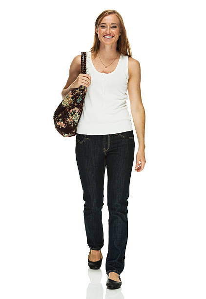 istock Cheerful woman walking & holding purse 515744999