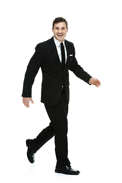 istock Cheerful businessman walking & looking at camera 515745001