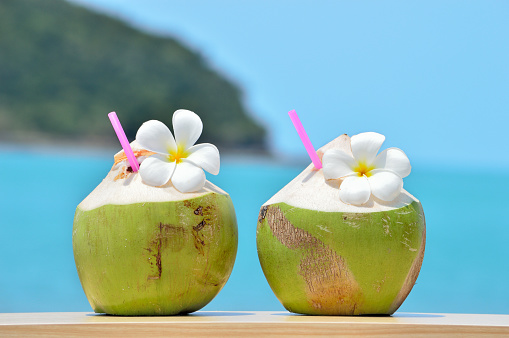 Tropical fresh coconut cocktail decorated plumeria on tropical caribbean