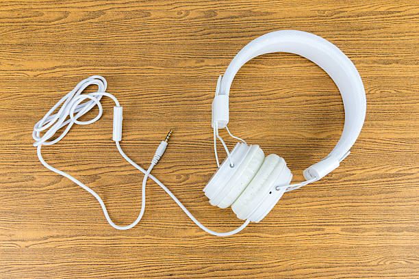 istock White headphone on wooden background 515746069