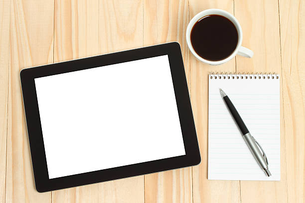 istock Tablet PC, cup of coffee with office supplies 515747313