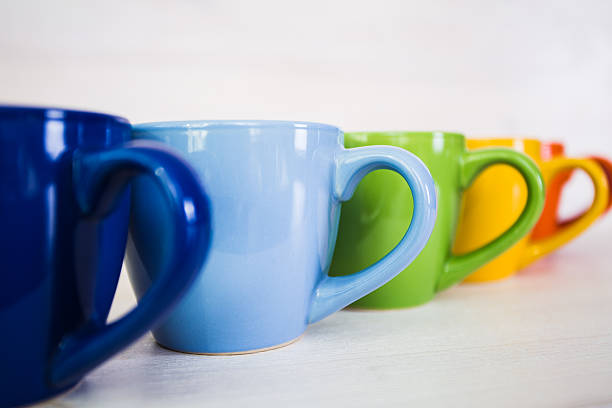 istock stack of colorful coffee cups on a white wooden background 515749076