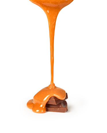 sweet caramel sauce is poured on a chocolate bar
