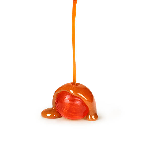 istock caramel candies and caramel sauce pouring 515750274