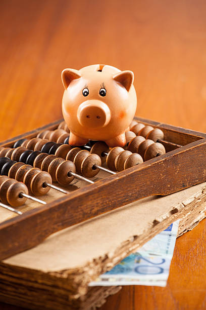 Piggy bank on wooden abacus stock photo