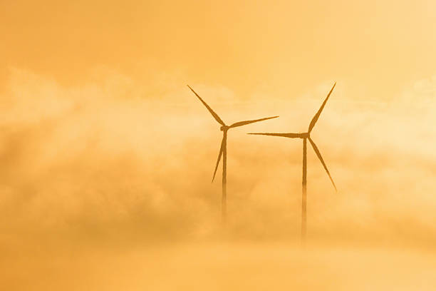 istock Wind turbines in misty sunrice 515770275