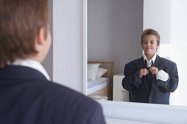 I'm gonna' be just like my dad Shot of a young boy wearing his father's suit and pretending to be a businessman too big stock pictures, royalty-free photos & images