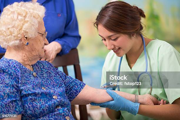 Home Healthcare Nurse Giving Injection To Elderly Woman Stock Photo - Download Image Now