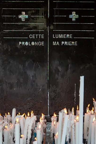 Photo of Burning candles in a church at Lourdes