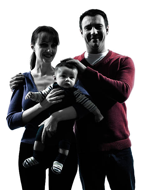 istock parents with baby portrait silhouette 515772367