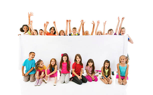 istock Large group of cheerful children holding white banner. 515772545