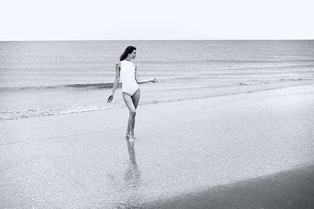 istock Woman in white bathing suit on sea background 515773051