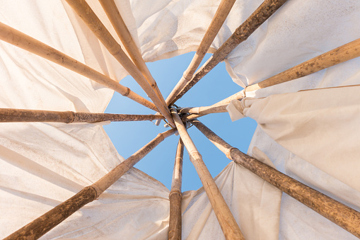 Look up in sky inside a Native American Indian tepee.