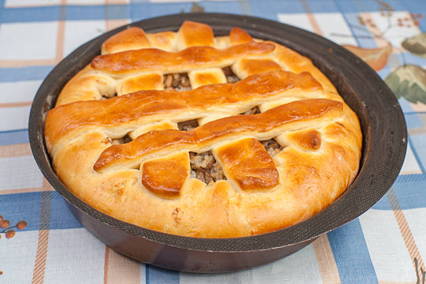 Making pie. Tasty pie with filling in black metal baking form