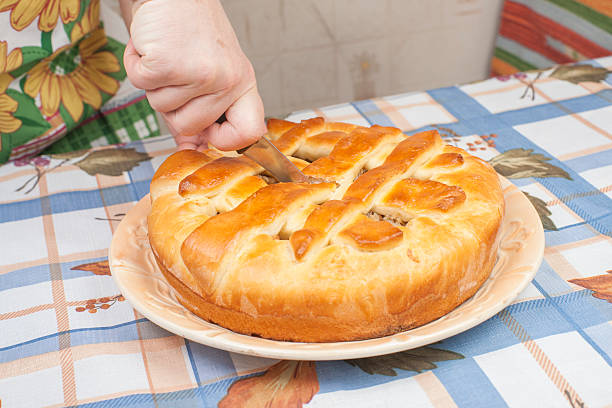 Making pie. Cutting the tasty pie with filling on the plate