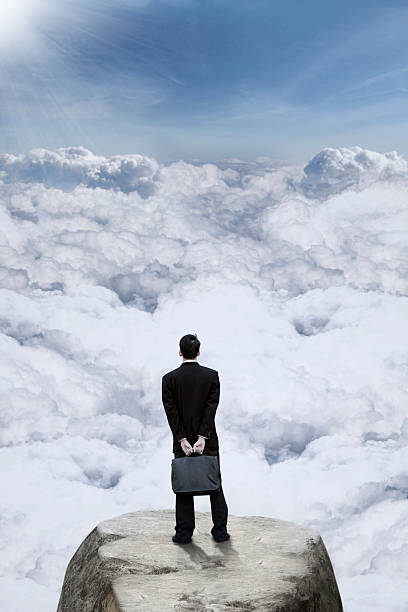 istock Businessman looking at clouds on the mountain 515778814