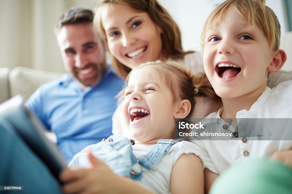 Happy family Children sitting together with parents and laughing Family Stock Photo