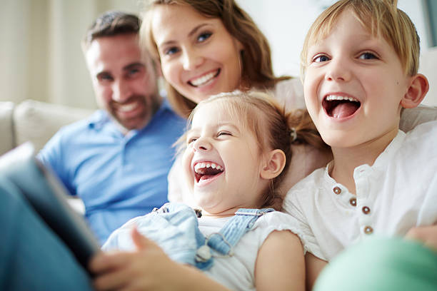 Happy family Children sitting together with parents and laughing children laughing stock pictures, royalty-free photos & images