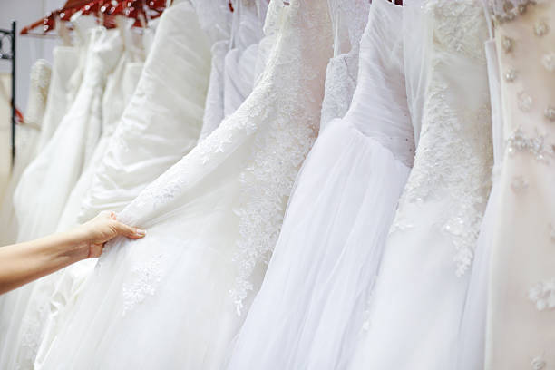 Beautiful wedding dresses on a hanger  in bridal shop