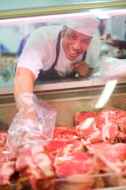 istock male butcher helping customer 515780020