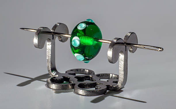 istock Green transparent glassy bead on the needle 515780628