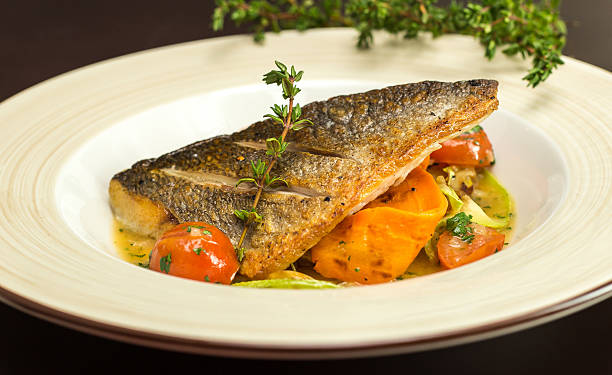 istock Grilled dorado fish with fried potatoes, lemon and tomato 515780788