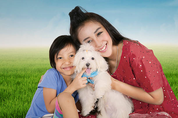istock Happy mother and her daughter holding dog 515783178