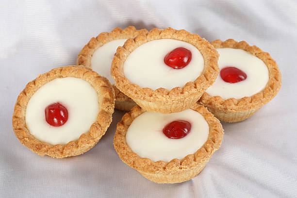 cherry bakewells five cherry bakewell cakes on a white cloth bakewell photos stock pictures, royalty-free photos & images