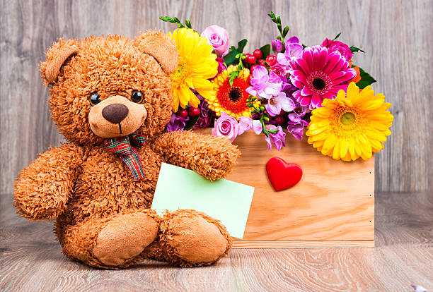 istock Bunch of flowers and a teddy bear 515783640
