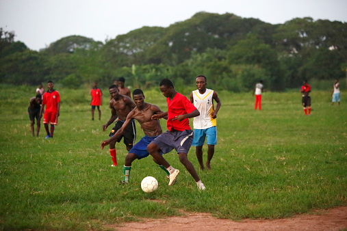 Soccer player kicking the ball on the field