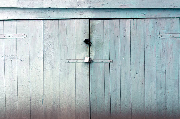 istock Blue weathered locked wooden door. 515783894