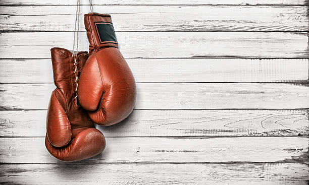 istock Boxing gloves hanging on wooden wall 515784085