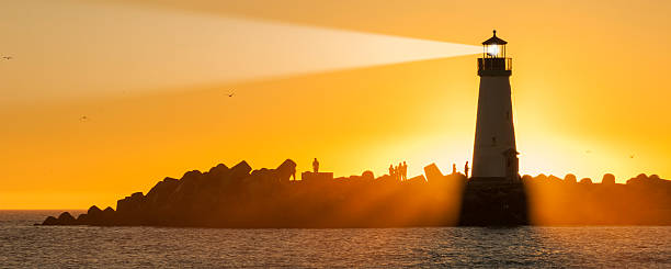 Light house with sunset in the background stock photo