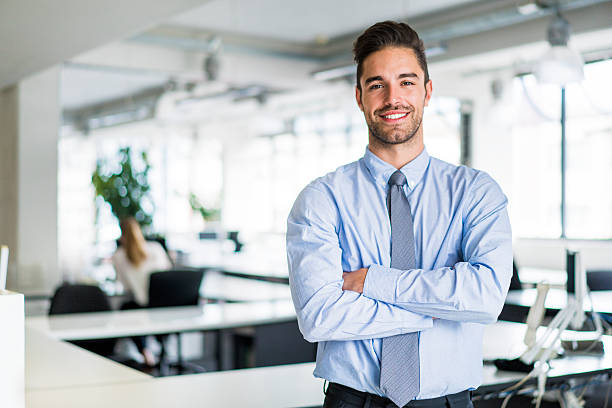 istock Happy businessman standing arms crossed in office 515785174