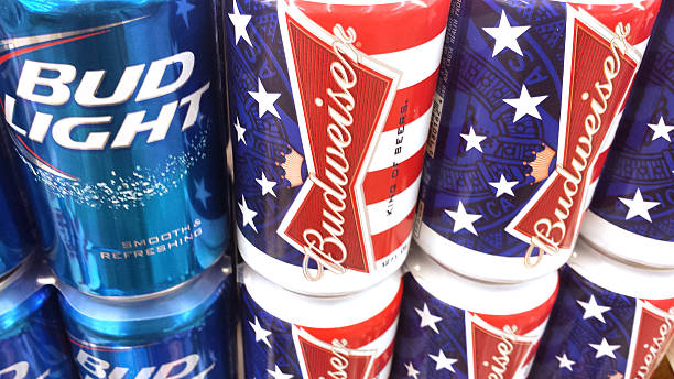 Beer Los Angeles, California, USA - July 1, 2013: Budweiser, the quintessential American beer, issues beer cans commemorating July 4th. The beer stays cool on market shelf while on display. can of bud light stock pictures, royalty-free photos & images